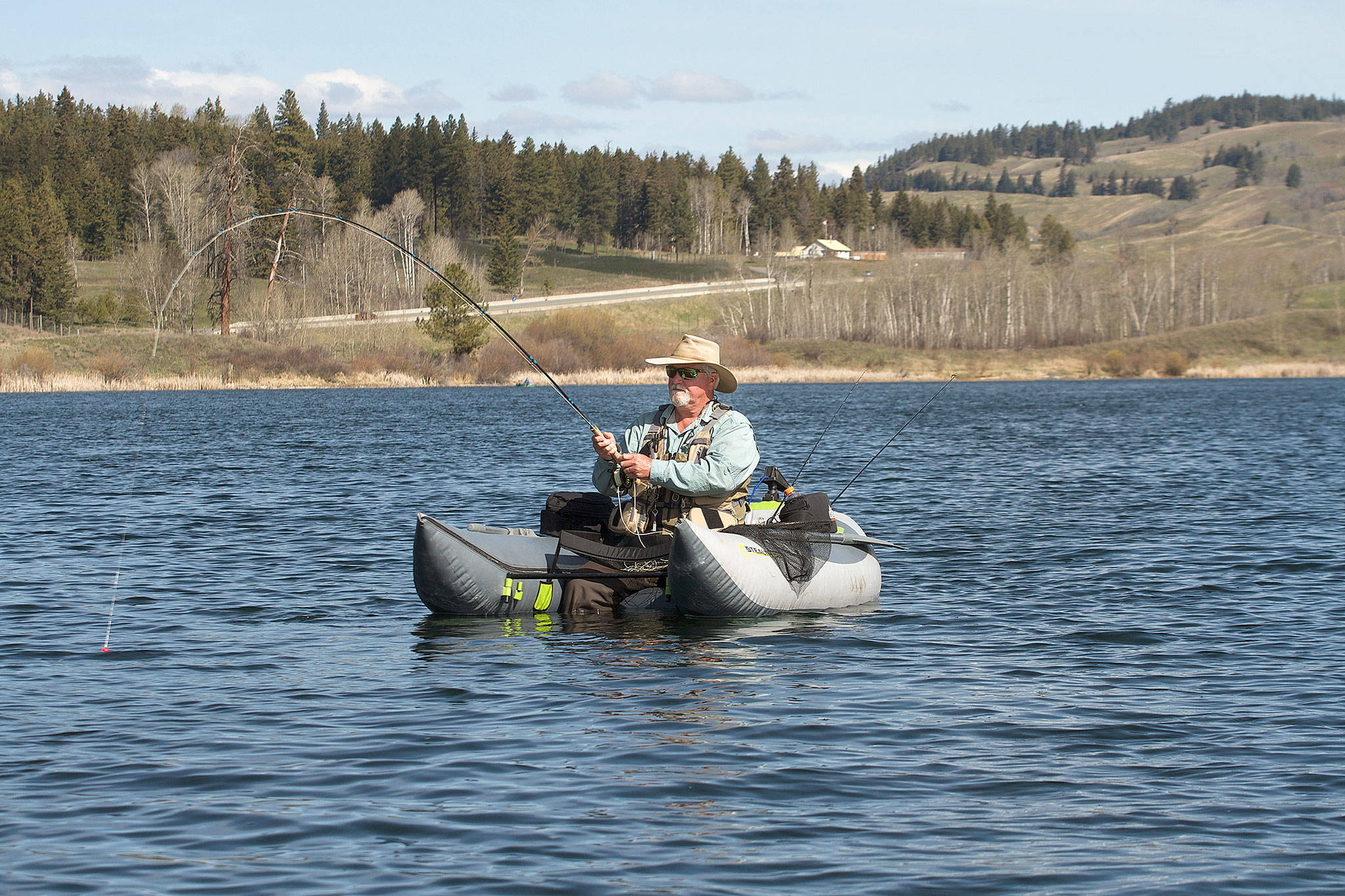 Dick Snow of Marysville lands a nice rainbow trout that grabbed a fly fished under a strike indicator. (Mike Benbow)