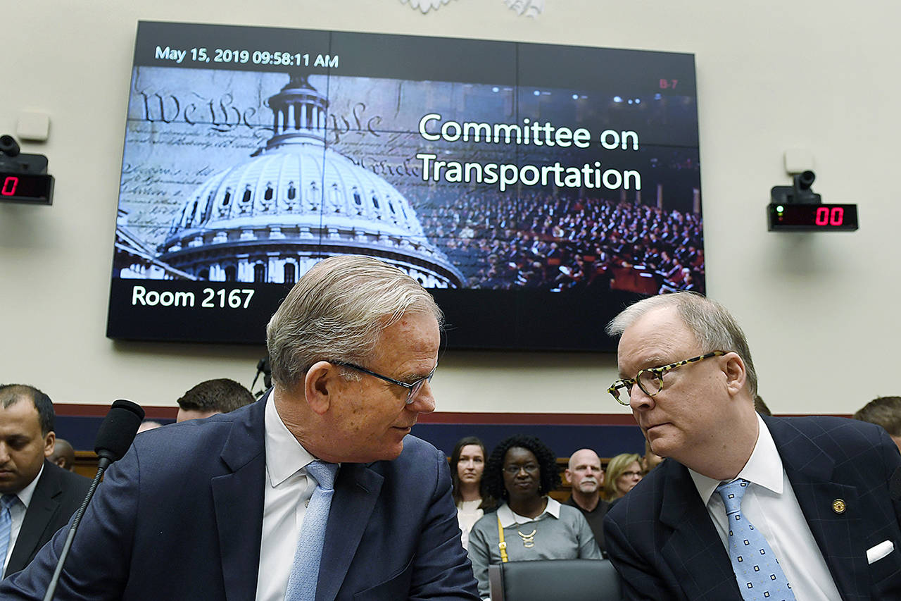 Daniel Elwell (left), acting administrator of the Federal Aviation Administration, and Robert L. Sumwalt (right), chairman of the National Transportation Safety Board, talk before the start of a House Transportation Committee hearing on Capitol Hill in Washington on May 15 on the status of the Boeing 737 MAX aircraft. A second hearing is planned for June 19. (AP Photo/Susan Walsh)