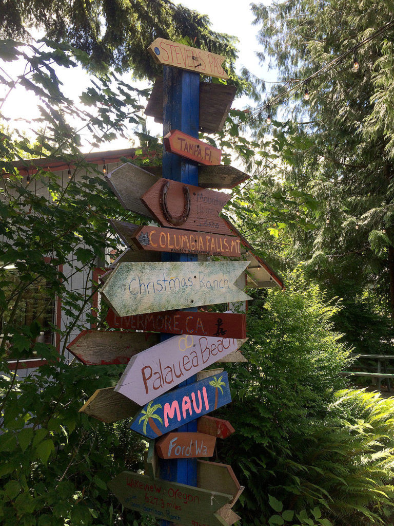 The drive-in has outdoor and indoor seating, as well as a few vintage mementos like these way signs. (Evan Thompson / The Herald)
