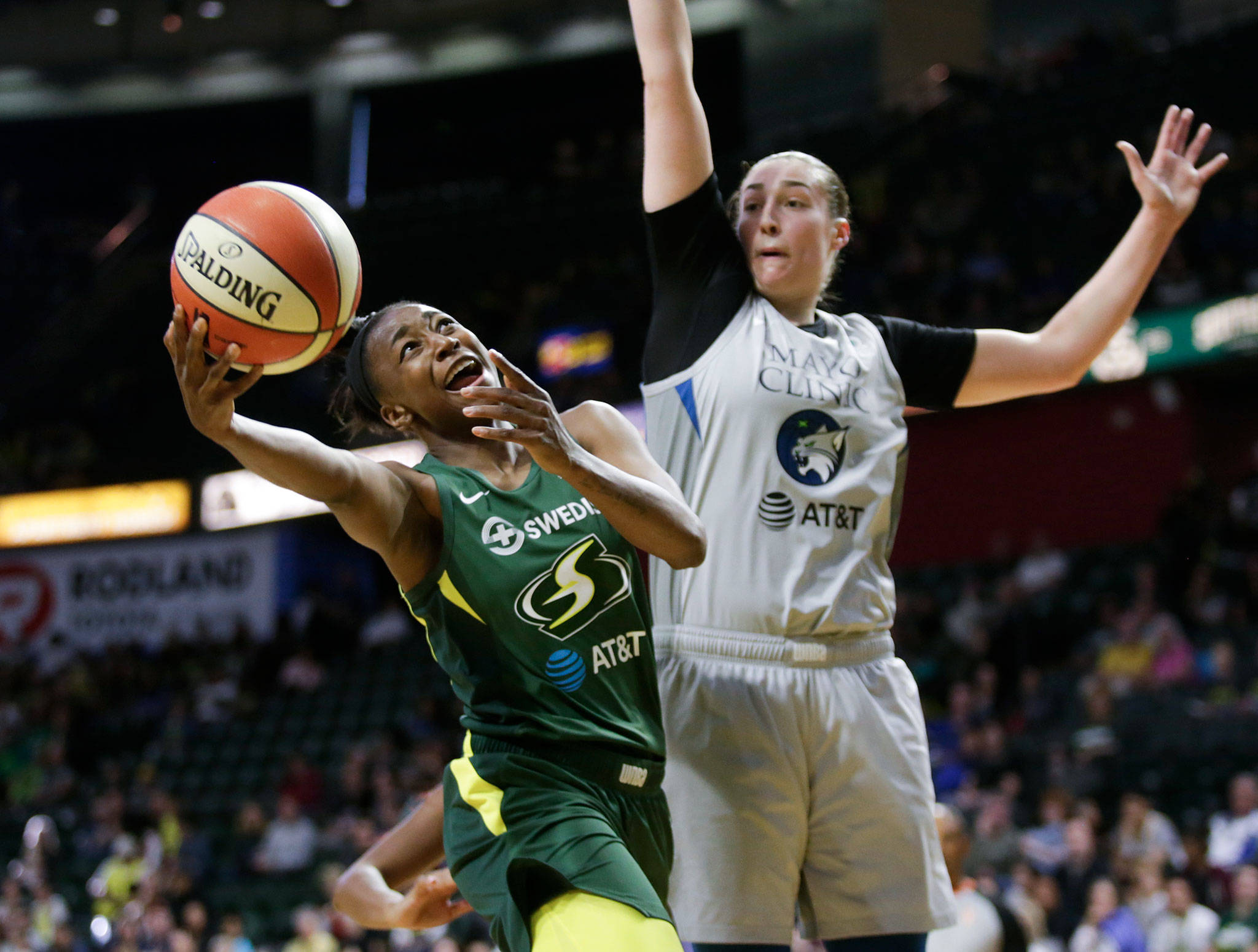 The Storm’s Jewell Loyd shoots as the Lynx’s Jessica Shepard defends during a game on June 4 at the Angel of the Winds Arena in Everett. (Andy Bronson / The Herald)