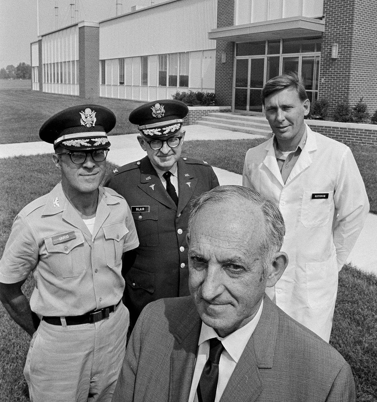 Dr. Seymour D. Silver (front), director of research labs at Edgewood, Maryland, and his staff (from left) Col. Henry T. Uhrig, director of medical research labs, Col. Joseph R. Blair, deputy director for medical sciences, and Lt. Col. James Ketchum, chief of the clinical research department, pose in front of the buildings that make up the “Nerve Gas Capital of America,” on Sept. 23, 1969. At this secluded old Army post were 70 human guinea pigs who were used to test chemical warfare weapons. (AP Photo/Bob Daugherty, file)