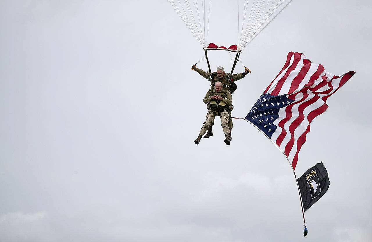 U.S. World War II D-Day veteran Tom Rice, from Coronado, California, parachutes in a tandem jump into a field in Carentan, Normandy, France, on Wednesday. (AP Photo)