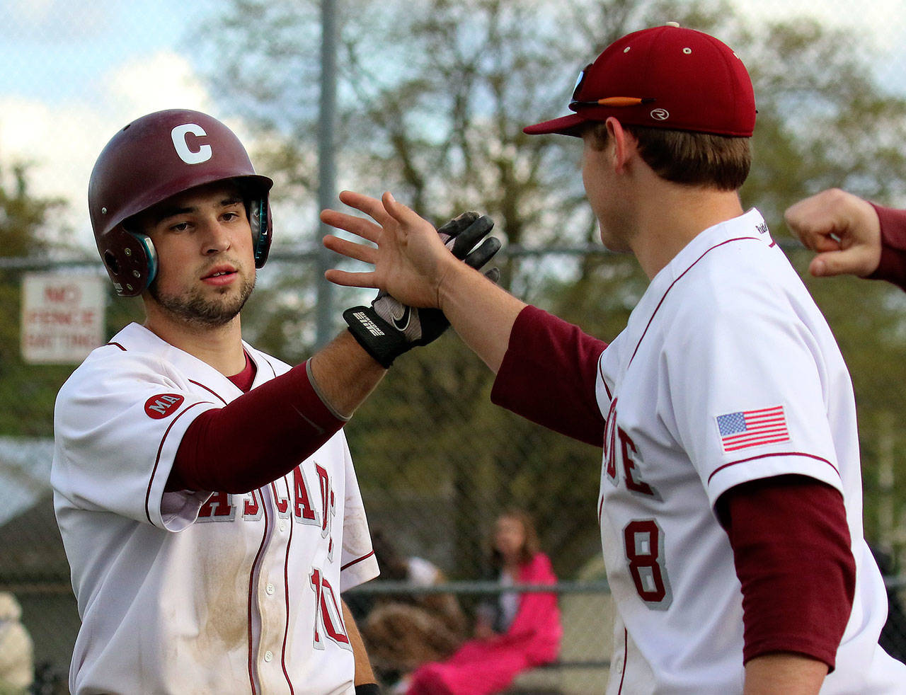 Cascade High School baseball player Austin Pinorini, left, is congratulated by Michael Carter for a score against Lake Stevens on April 29, 2015, in Everett. On Wednesday, he was selected 670th overall by the Cleveland Indians in the Major League Baseball draft. (Kevin Clark / The Herald)