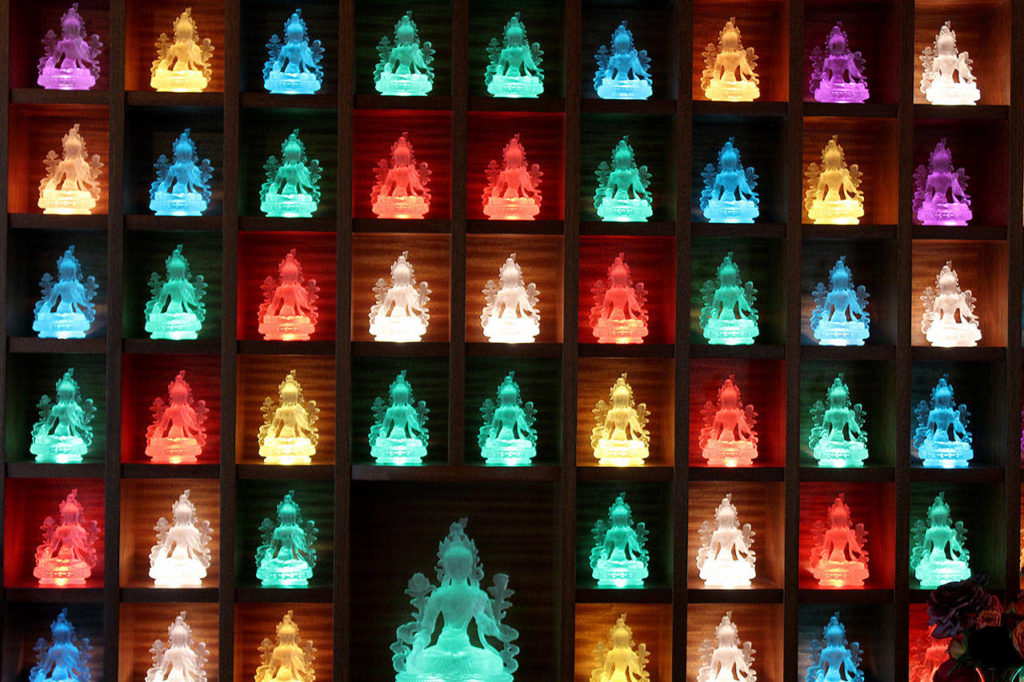 Lit-up glass statues of the goddess, Tara, shine from two corners of the sanctuary. Photo by Patricia Guthrie/Whidbey News Group
