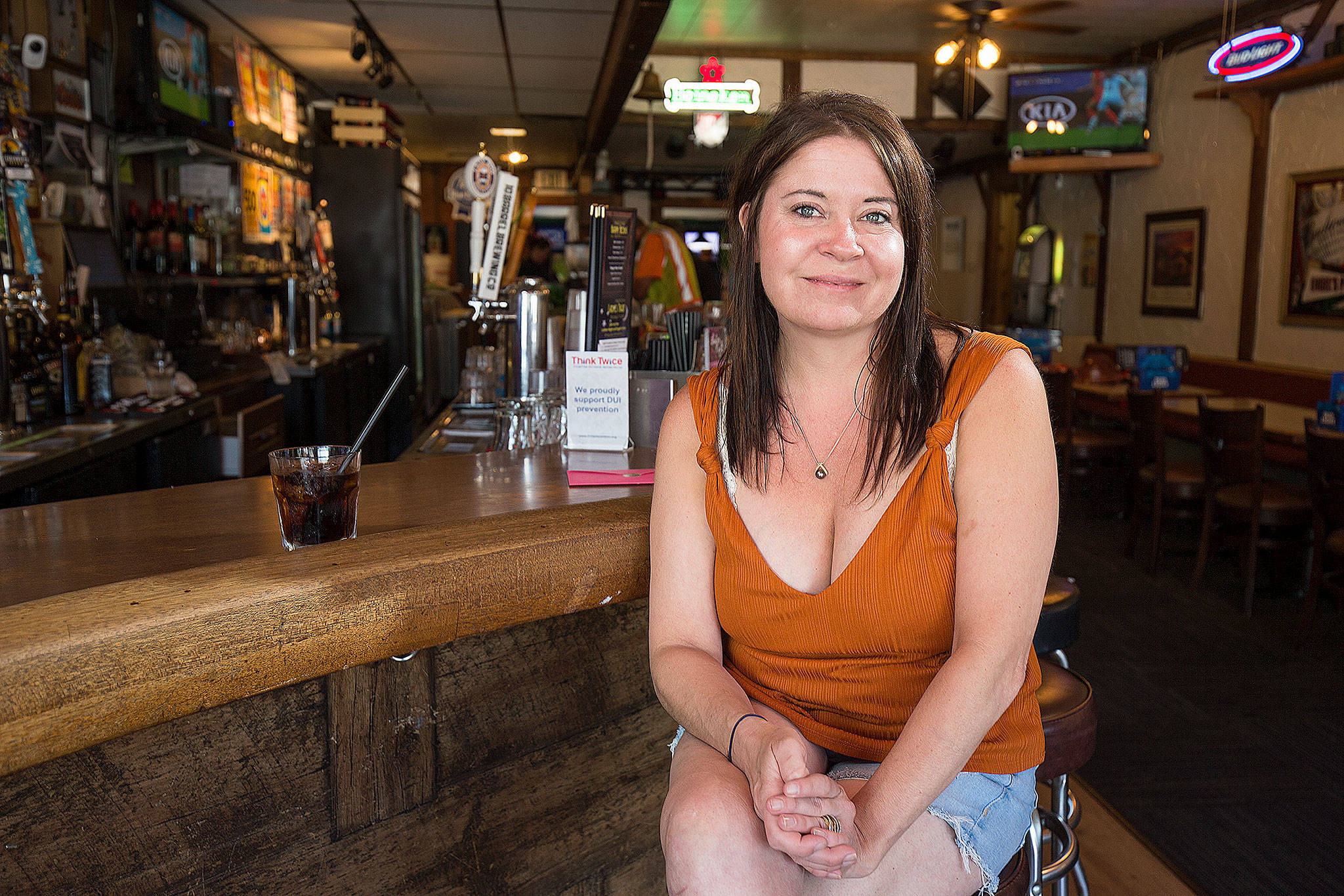 Nicole Geer tends bar at Engel’s Pub, one of the oldest businesses in Edmonds. (Andy Bronson / The Herald)