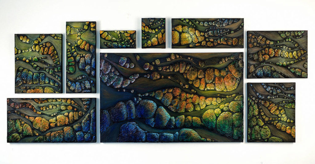 “Light Connections” is a 4-by-8-foot multi-canvas piece made with old quilts and acrylics. Shinn based it on a desire to find the light within the darkness of our politically tumultuous times.
