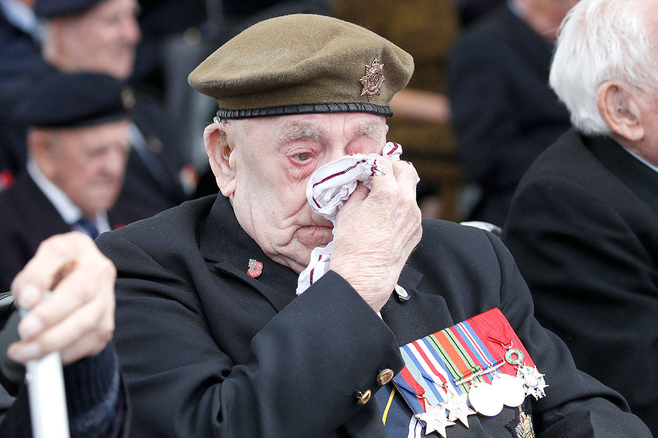 A veteran wipes his eyes during a ceremony to mark the 75th anniversary of D-Day, Wednesday in Portsmouth, England. (AP Photo/Alex Brandon)