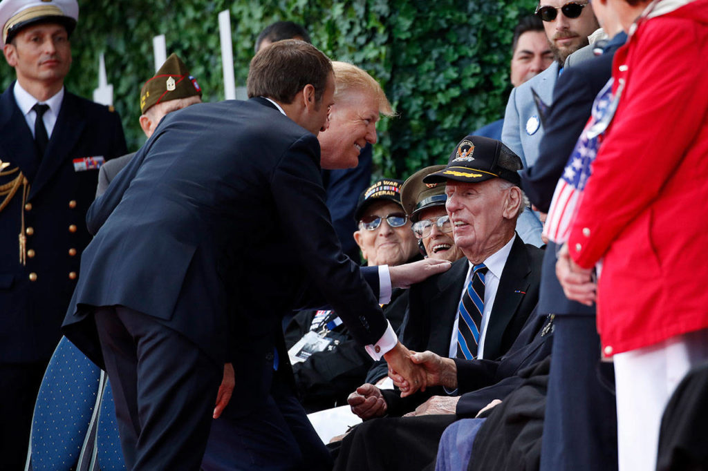 President Donald Trump and French President Emmanuel Macron greet veterans as they arrive to a ceremony to commemorate the 75th anniversary of D-Day at The Normandy American Cemetery on Thursday in Colleville-sur-Mer, Normandy, France. (AP Photo/Alex Brandon)
