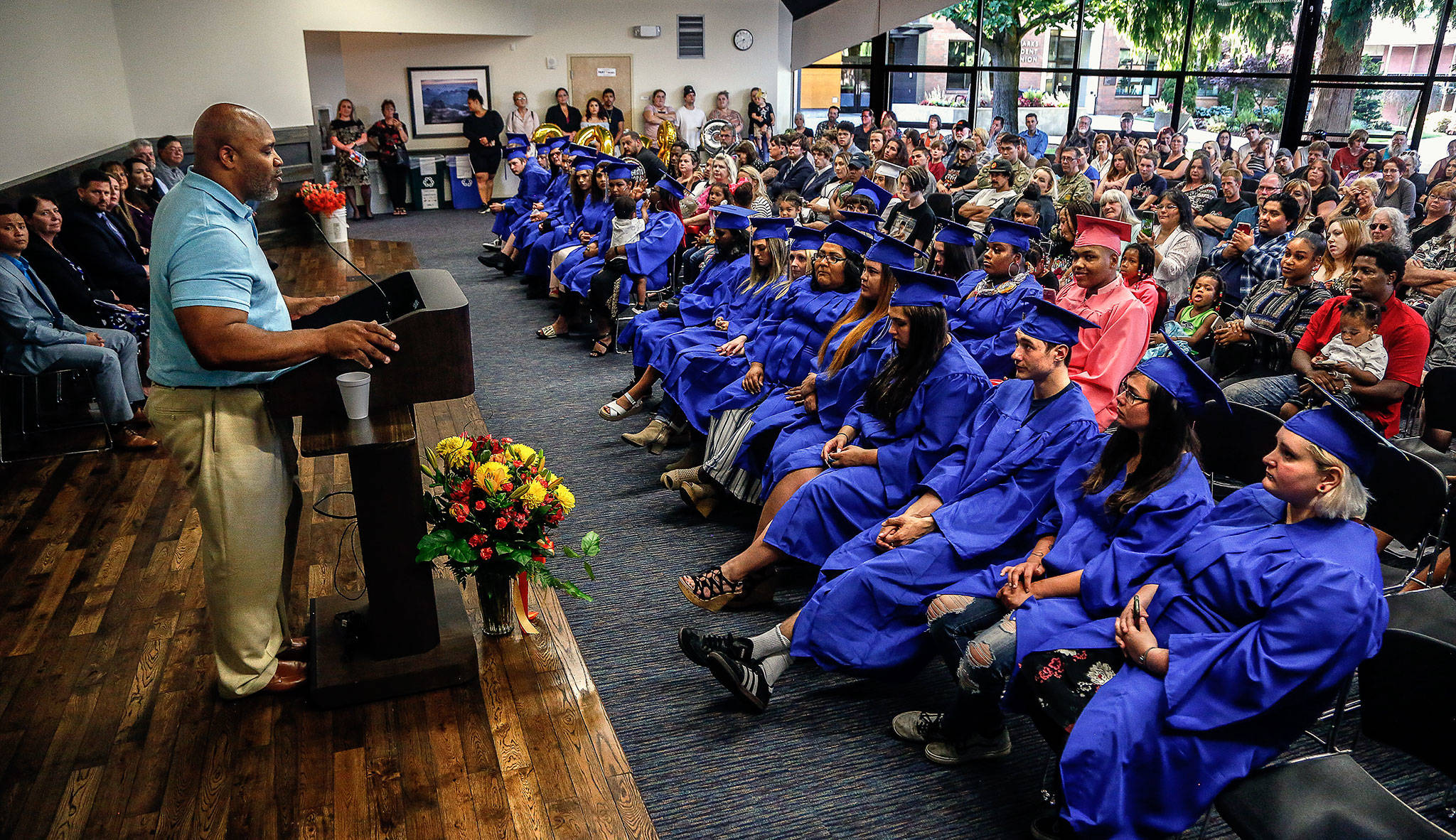 Keynote speaker Greg Lewis addresses WorkSource Youth Center graduates and guests Monday night at EvCC’s Henry M. Jackson Conference Center. Lewis used his football experience to illustrate how to handle obstacles by changing one’s game plan. (Dan Bates / The Herald)