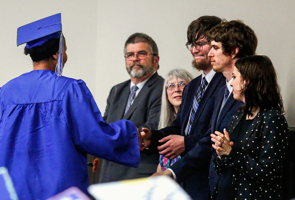 The family of Matthew Colson, who was killed by a hit-and-run driver in February, meets Faith-Cheri Friendly (left), who is receiving one of four Matthew Colson Perseverance Awards Monday night during a graduation ceremony. Family members (from left) are Matthew’s father Marion Colson, mother Kim, and siblings Isaac, Caleb and Rachel. (Dan Bates / The Herald)
