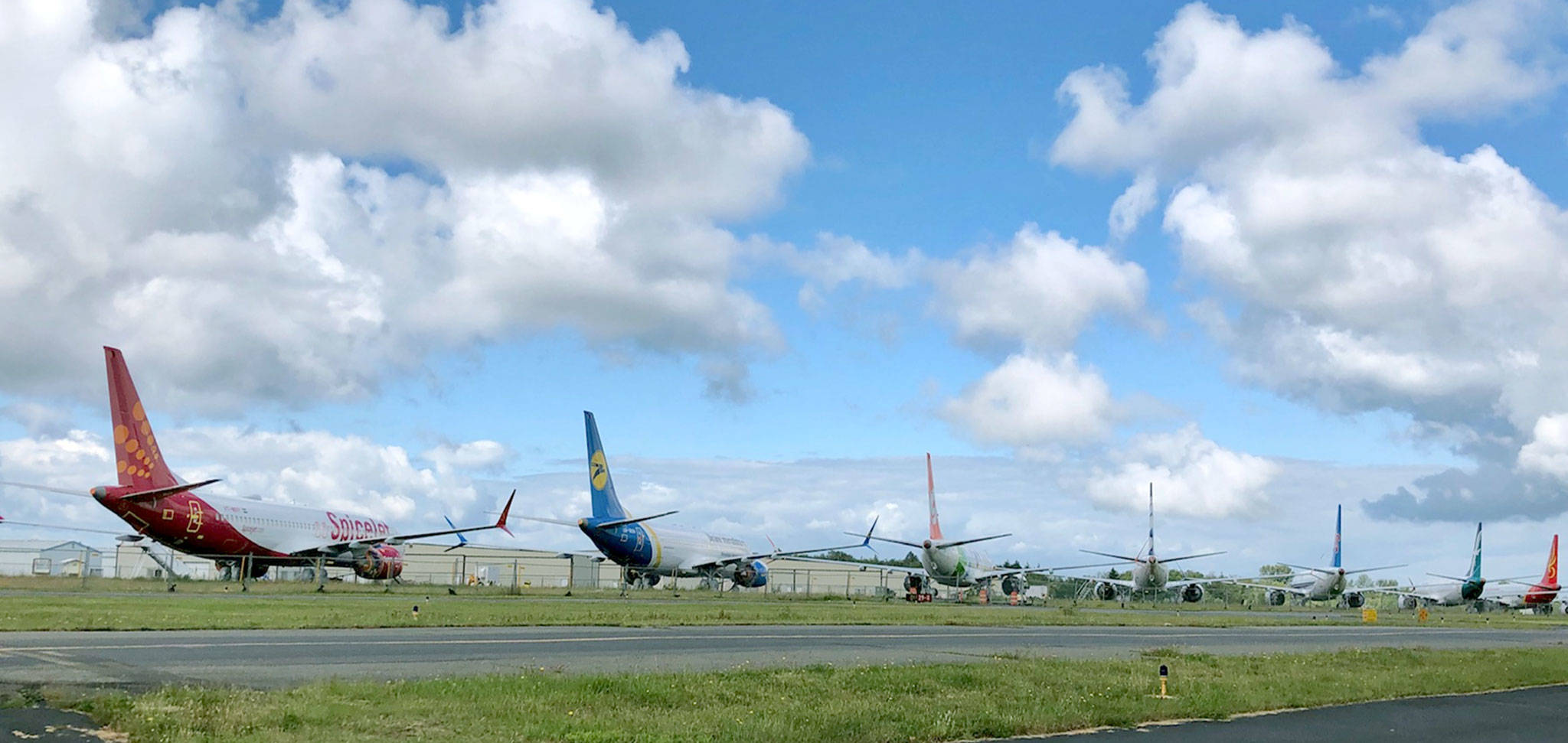 Boeing 737 Max airplanes are parked on the crosswind runway at Paine Field in Everett on June 6, 2019. (Janice Podsada / The Herald)