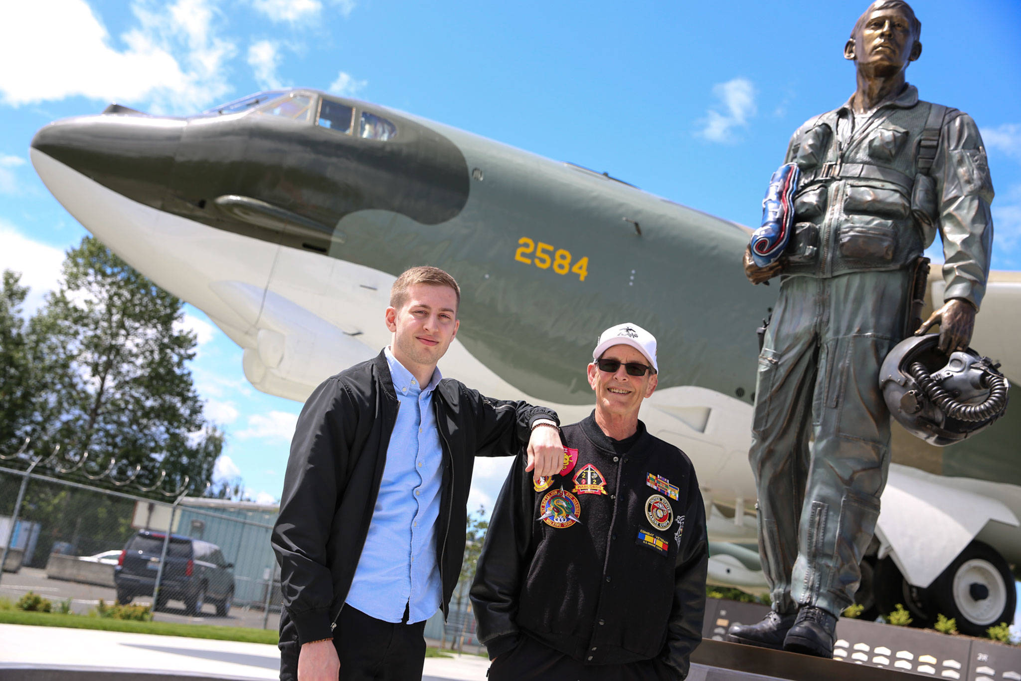 Evan Thompson and his father, Jim Thompson, near a restored B-52 at Vietnam Veterans Memorial Park in Tukwila. The elder Thompson served in Vietnam, and credits the bomber for helping him survive the war. (Kevin Clark / The Herald)