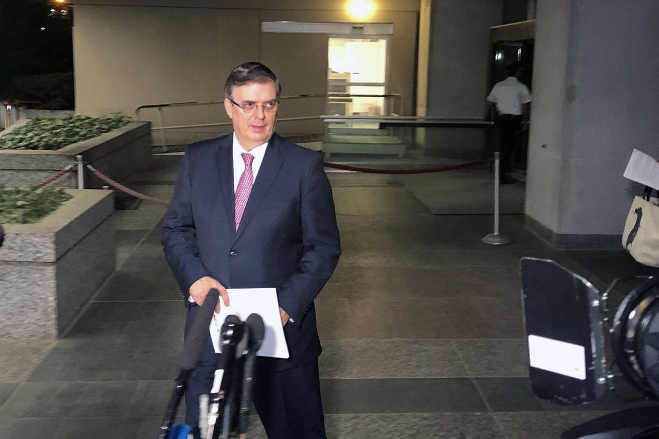 Mexican Foreign Minister Marcelo Ebrard gets ready to talk to reporters as he leaves the Department of State in Washington on Friday. President Donald Trump says he has suspended plans to impose tariffs on Mexico, tweeting that the country “has agreed to take strong measures” to stem the flow of Central American migrants into the United States. (AP Photo/Luis Alonso Lugo)