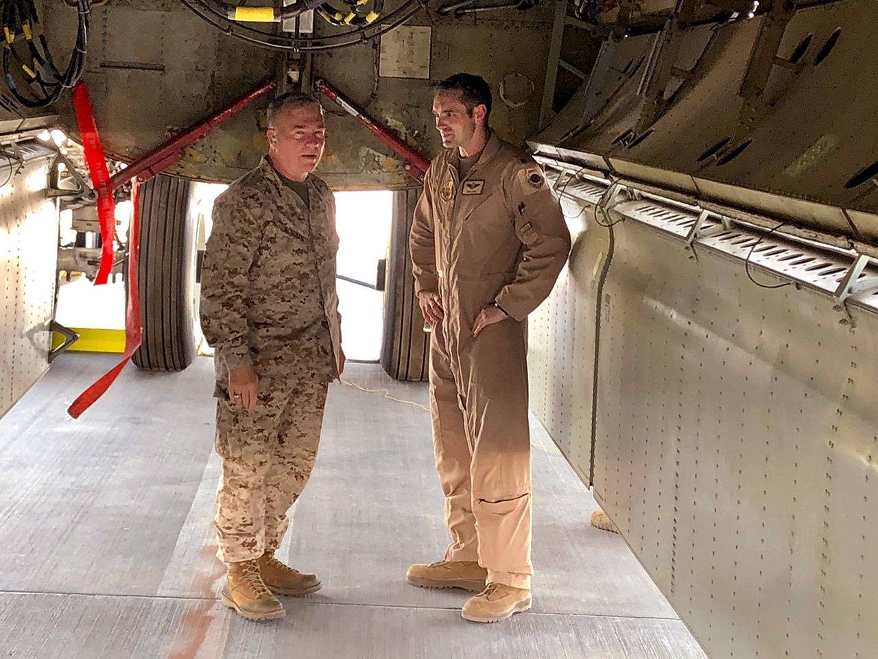 Marine Gen. Frank McKenzie, head of U.S. Central Command, confers with an Air Force officer below the bomb bay of a B-52 bomber on Friday at al-Udeid air base in Qatar. McKenzie said on Friday that he thinks Iran had been planning some sort of attack on shipping or U.S. forces in Iraq. Two other officials, speaking on condition of anonymity to discuss sensitive details, said Iran was at a high state of readiness in early May with its ships, submarines, surface-to-air missiles and drone aircraft. “It is my assessment that if we had not reenforced, it is entirely likely that an attack would have taken place by now,” he said. (AP Photo/Robert Burns)
