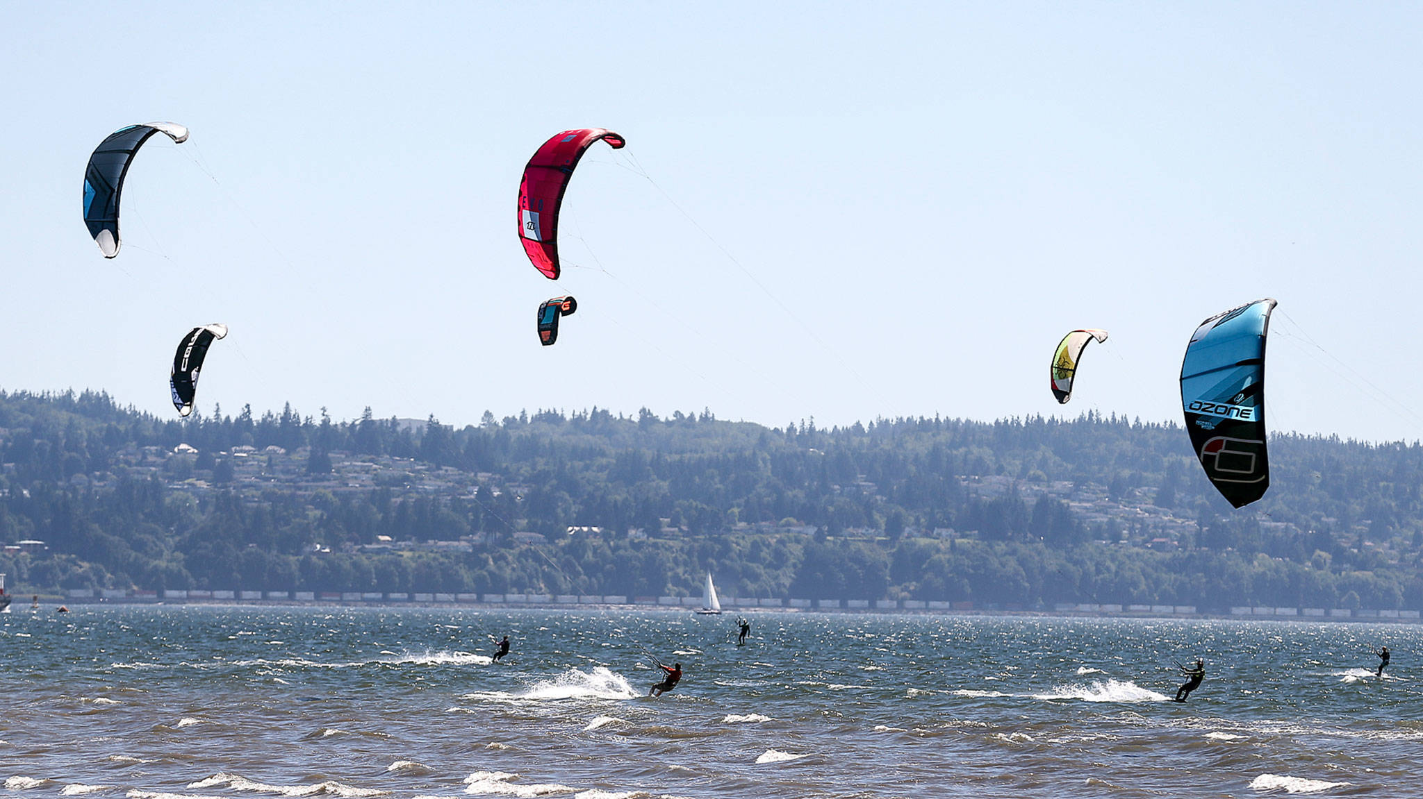 Kiteboarders dot the horizon during the 2017 Jetty Island Light Wind Olympics on June 23, 2017 near Everett. The 2019 edition of the event is scheduled for this weekend. (Kevin Clark / The Herald)