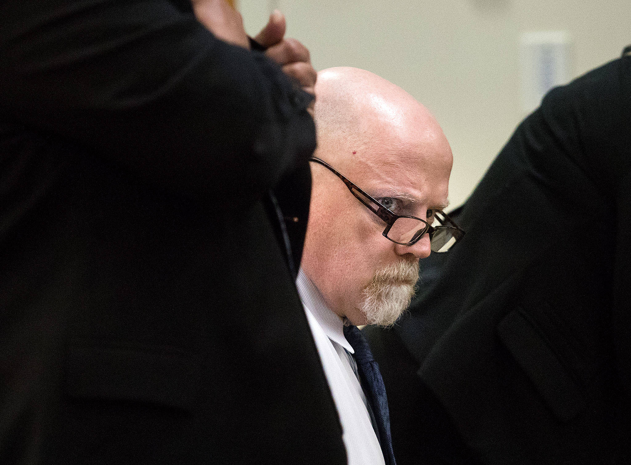 William Talbott II waits for potential jurors to file into Snohomish County Superior Court in Everett on Tuesday. (Andy Bronson / The Herald)