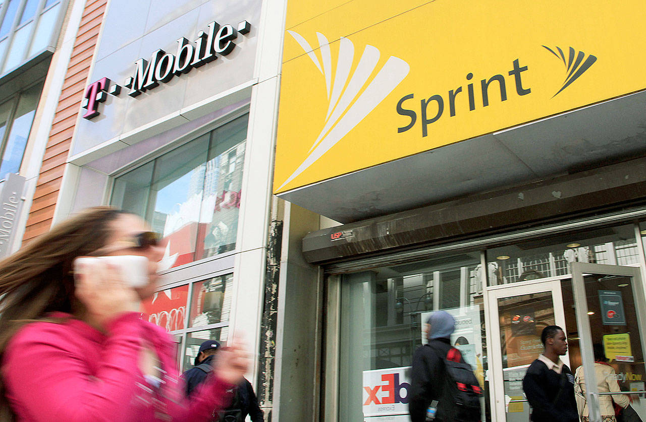 Published reports say a group of state attorneys general are planning a lawsuit to block a $26.5 billion merger of wireless carriers T-Mobile and Sprint. It’s an unusual step ahead of a decision by federal antitrust authorities. (AP Photo/Mark Lennihan, File)