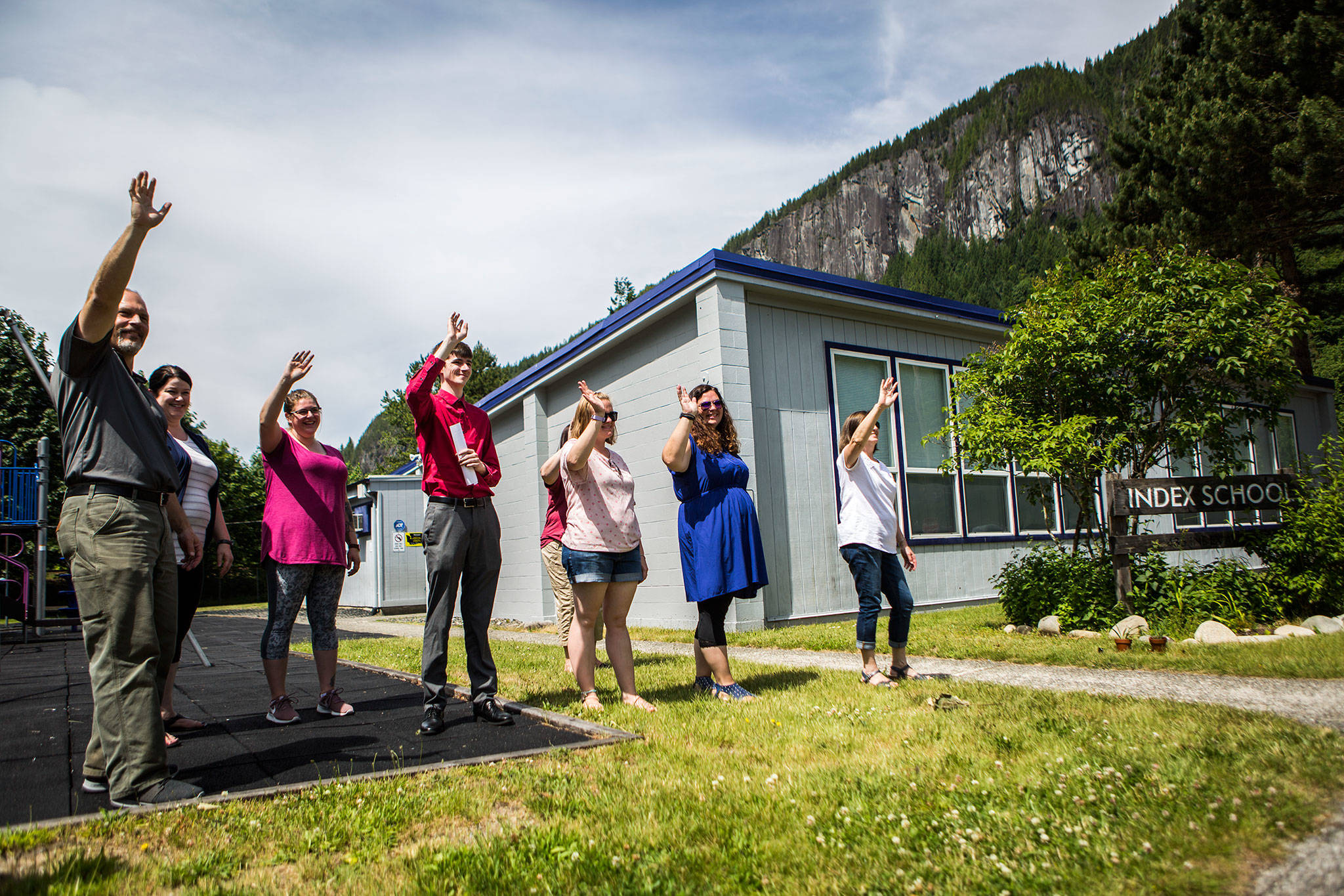 The Index Elementary staff waves goodbye to a handful of kids leaving in the school bus before summer break on June 12. (Olivia Vanni / The Herald)