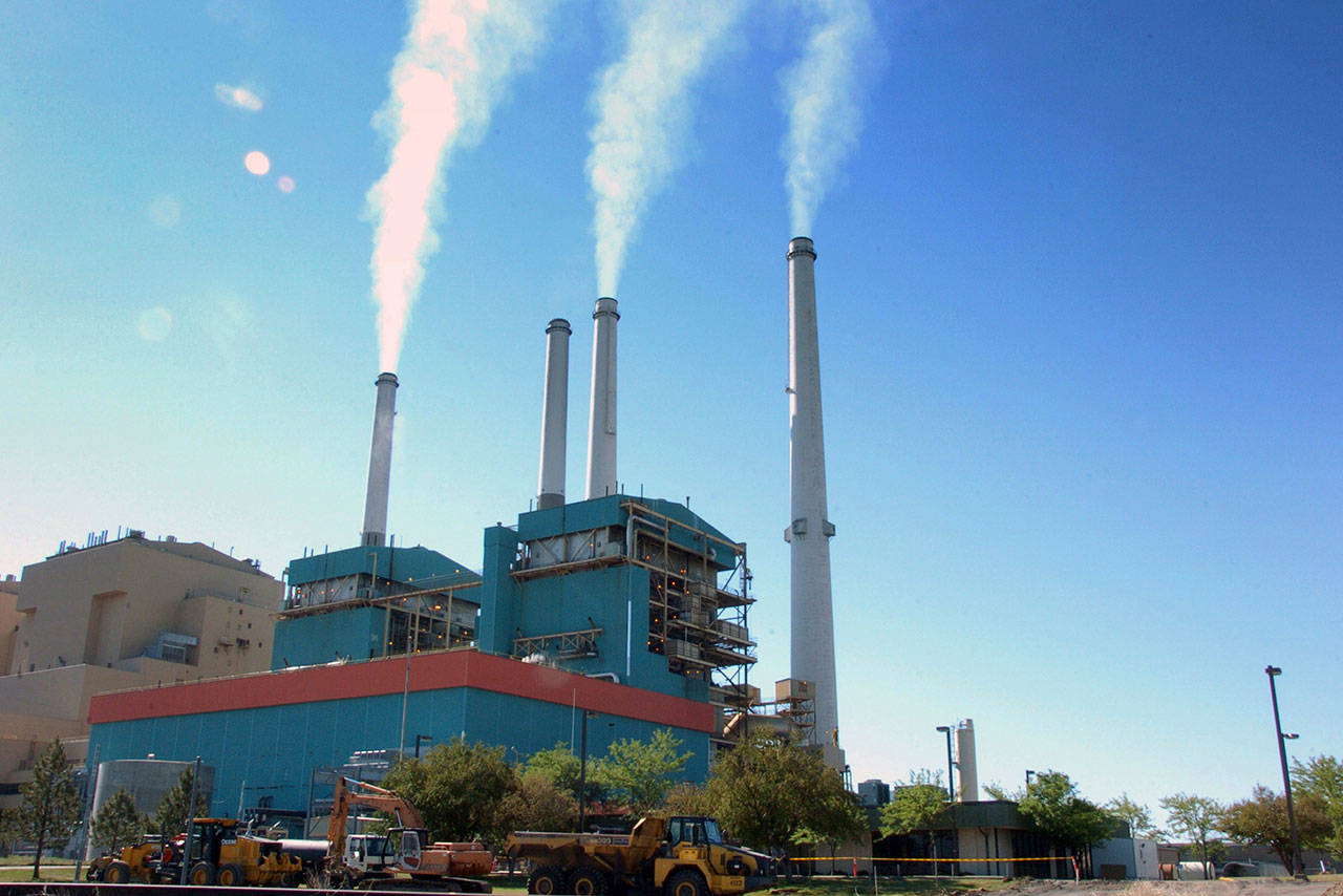 Smoke rises from the Colstrip Steam Electric Station, a coal power plant in Colstrip, Montana, in 2013. The plant’s operator said Tuesday that it plans to shut down two of the plant’s four units about 2½ years early, citing costs and the unwillingness of a coal supplier to lower costs. (AP Photo/Matthew Brown ,File)