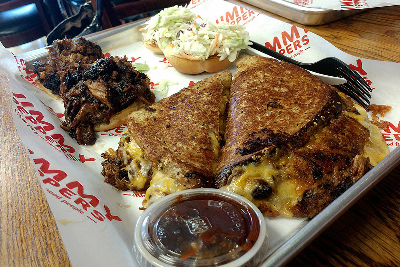 A tray with brisket and pulled pork sliders, plus pulled pork grilled cheese at Jimmy Peppers in Everett. (Sara Bruestle / The Herald)