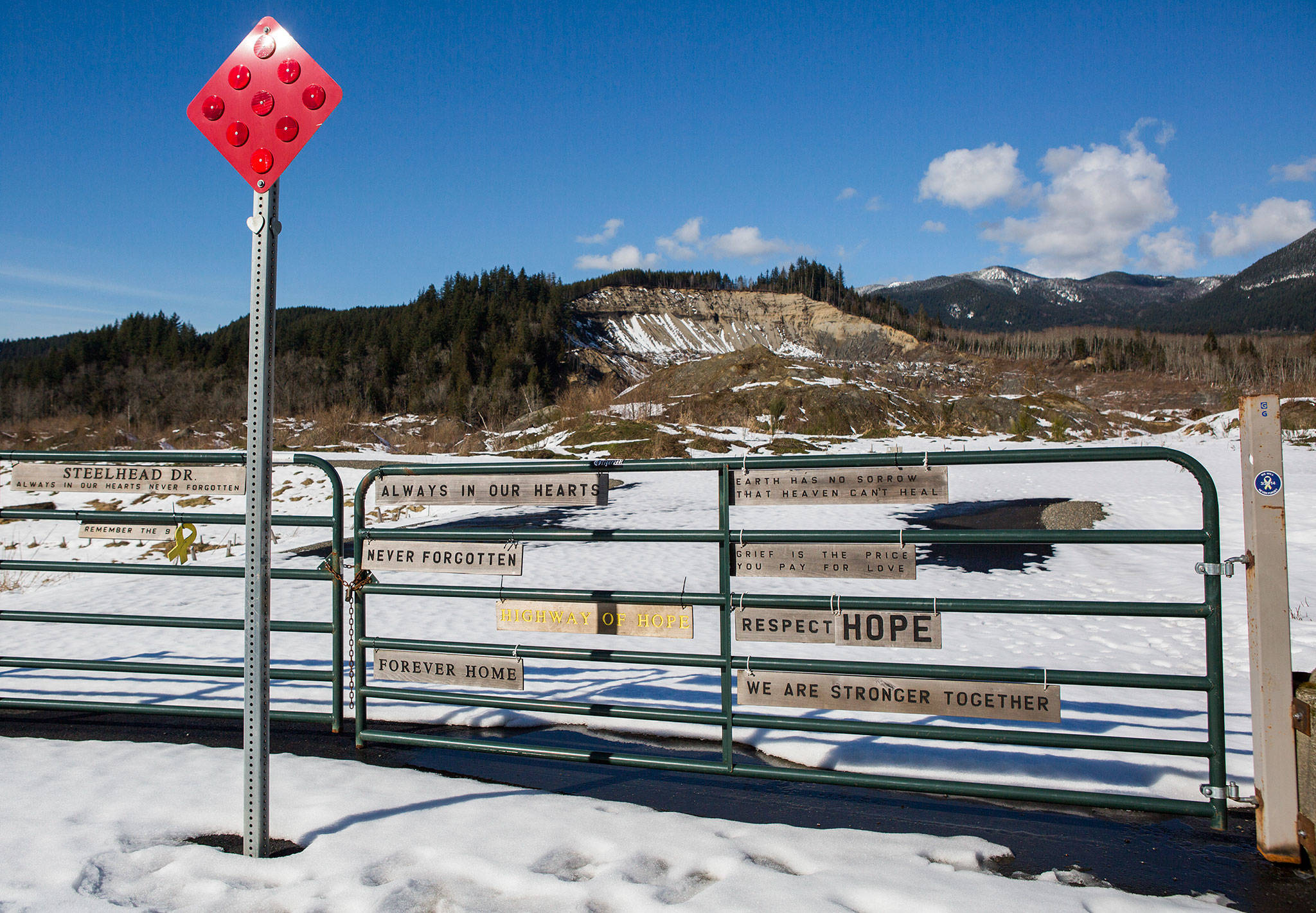 Snow covers the entrance to Steelhead Drive on Feb. 21, where the new Oso Memorial will be placed. (Olivia Vanni / The Herald)