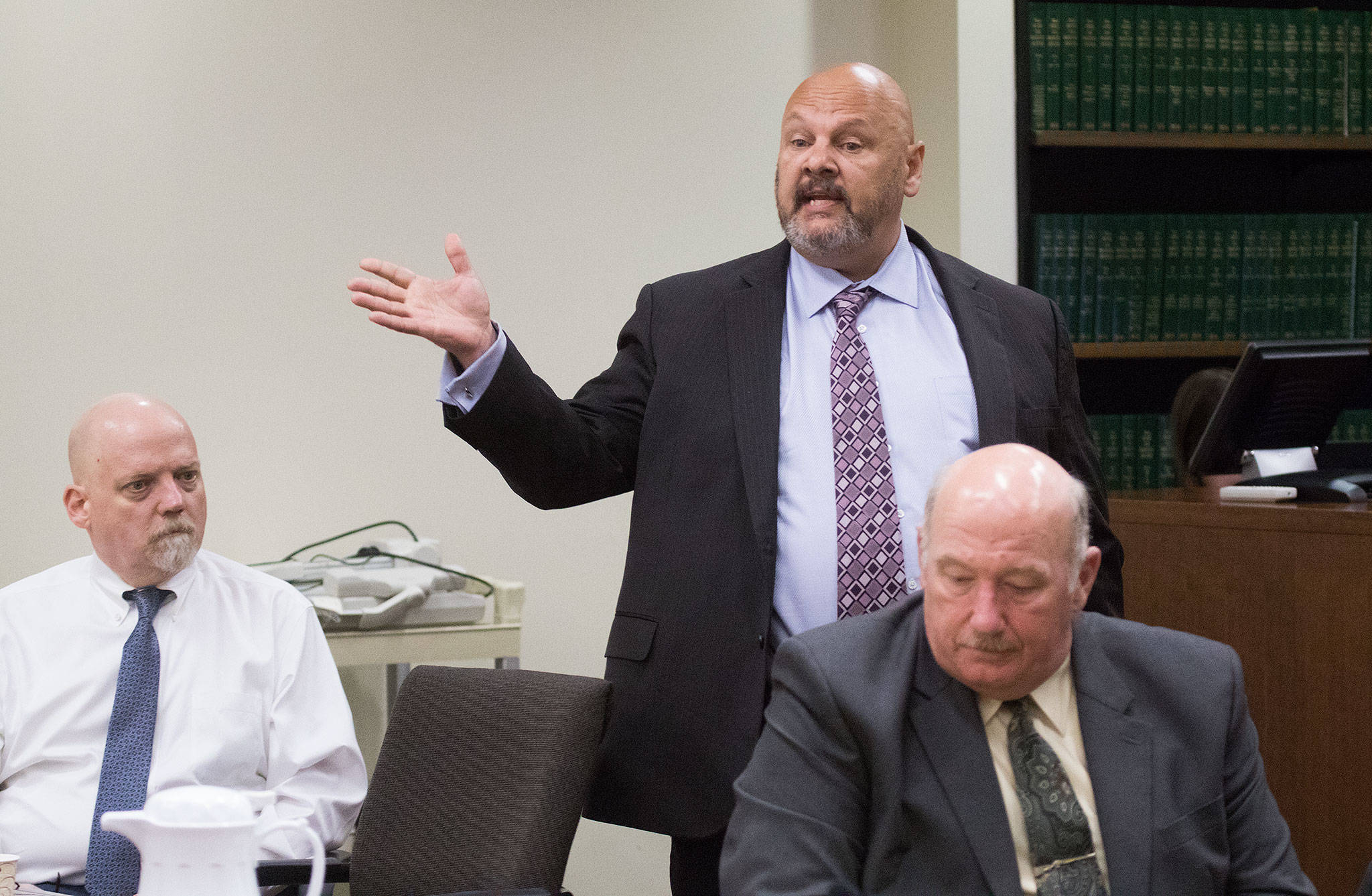 William Talbott II (left) listens as his public defender Jon Scott questions potential jurors at the Snohomish County Courthouse on Thursday in Everett. Snohomish County sheriff’s detective Jim Scharf (right) listens from the prosecutor’s table. (Andy Bronson / The Herald)