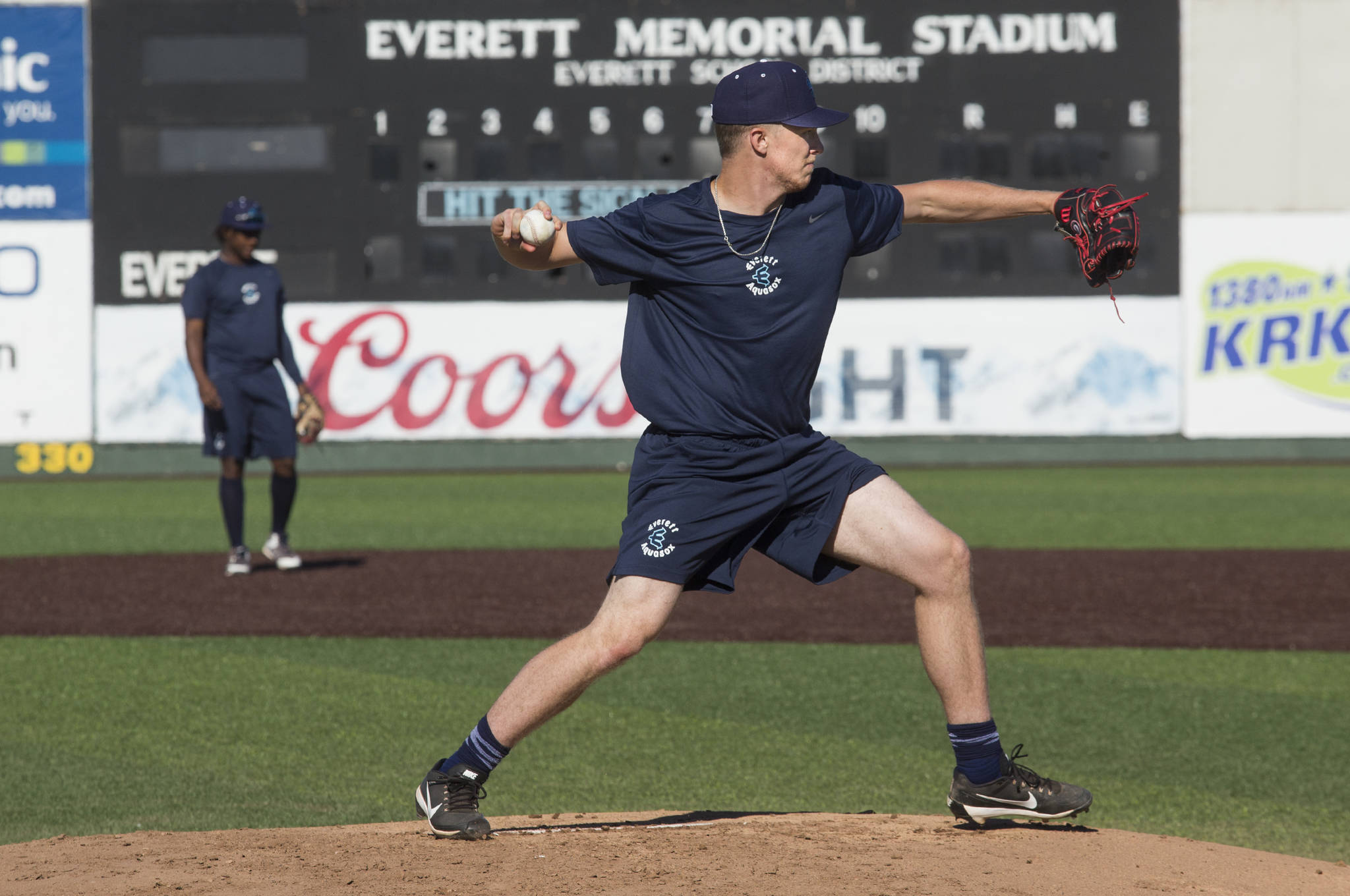 Andy Bronson / The Herald                                AquaSox pitcher Tim Elliott throws to first base on the first day of practice on Tuesday at Funko Field at Everett Memorial Stadium.