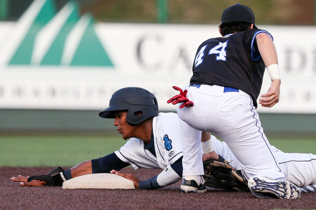 The AquaSox’s Miguel Perez beats the tag at second base by the Merchants’ Riley Parker during the Everett Cup on June 12, 2019, at Funko Field at Everett Memorial Stadium. (Kevin Clark / The Herald)
