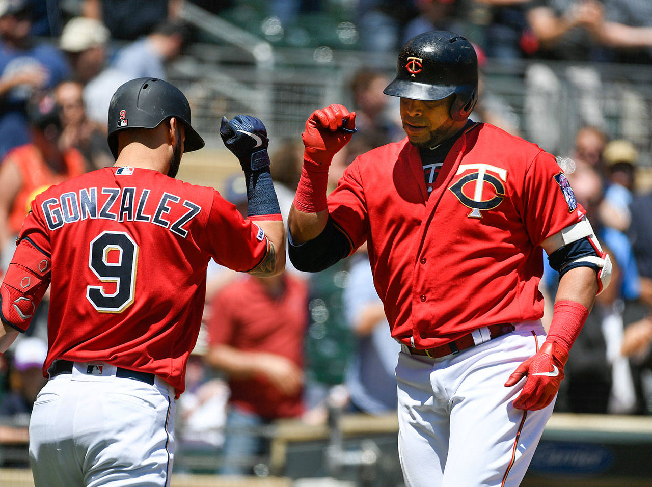 Twins designated hitter Nelson Cruz (right) celebrates with Marwin Gonzalez after hitting a solo home run during the third inning of a game against the Mariners on June 13, 2019, in Minneapolis. (AP Photo/Craig Lassig)