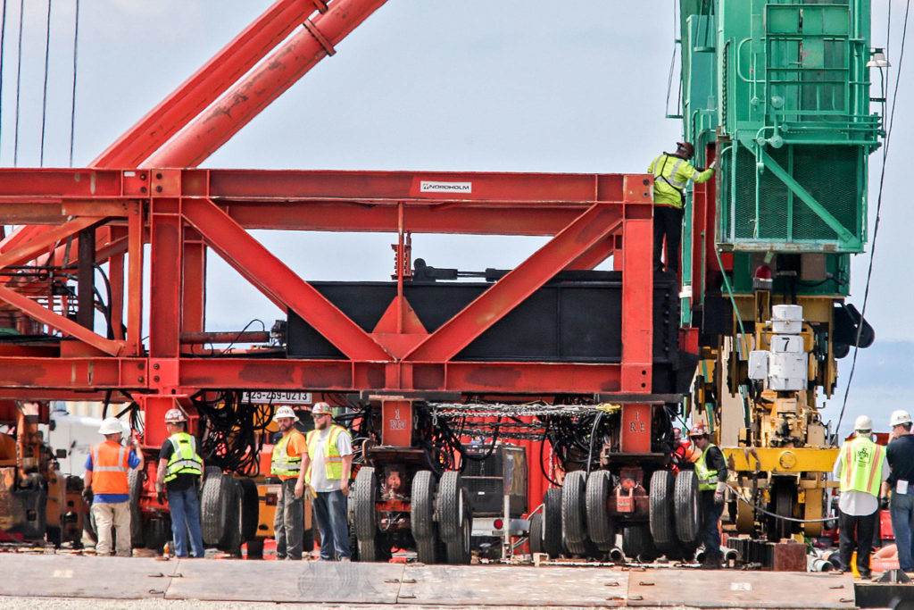 Crews work to move one of the newly arrived 214-foot port cranes at the South Terminal at the Port of Everett on Friday afternoon. (Kevin Clark / The Herald)
