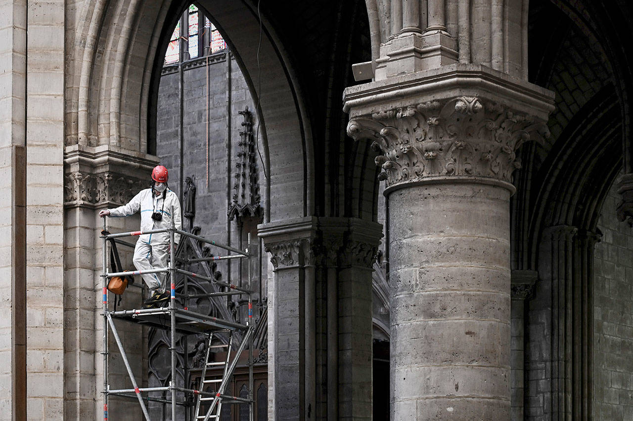 A worker stands on scaffolding during preliminary work inside the Notre Dame de Paris Cathedral in Paris on May 15. The billionaire French donors that publicly promised flashy donations totalling hundreds of millions to restore Notre Dame, have not yet paid a penny toward the restoration of the French national monument, according to church and business officials. Instead, it’s mainly American citizens that have footed the bills and paid salaries for the up to 150 workers employed by the cathedral since the April 15 fire. (Philippe Lopez/Pool via AP, File)