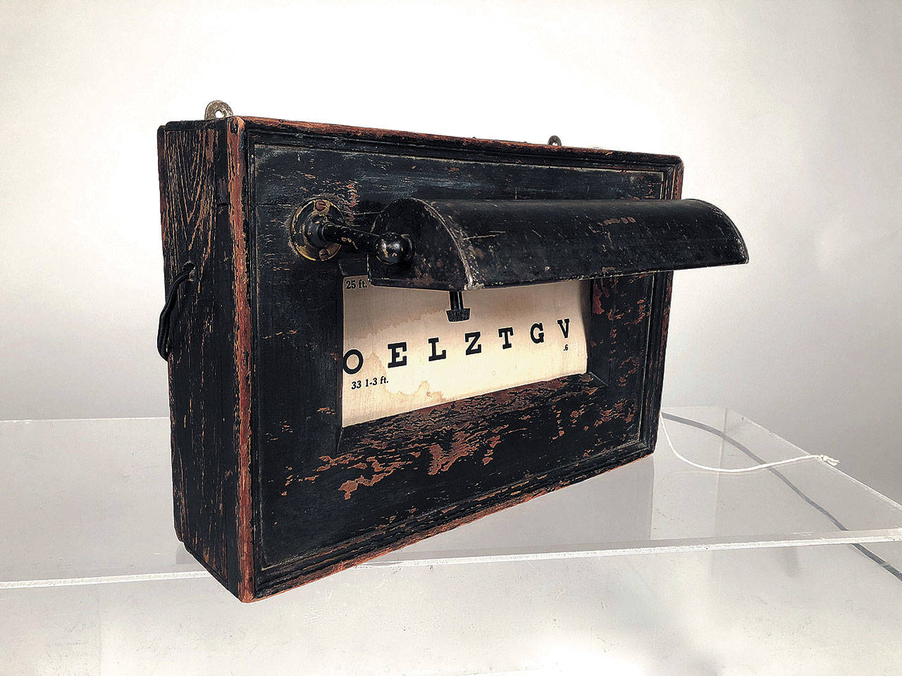 This 1880s optician’s eye test chart was made by Globe Optical Co. of Boston and was for sale in a Massachusetts antiques shop for $2,200. It’s painted wood with a metal lamp visor and has a linen scroll with rows of letters in graduated sizes. (Cowles Syndicate Inc.)
