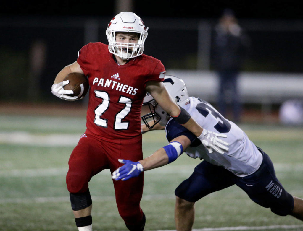 Snohomish’s Tyler Larson pushes off an opponent as to gain extra yardage against Squalicum at Veterans Memorial Stadium on Oct. 26, 2018 in Snohomish. (Andy Bronson / The Herald)
