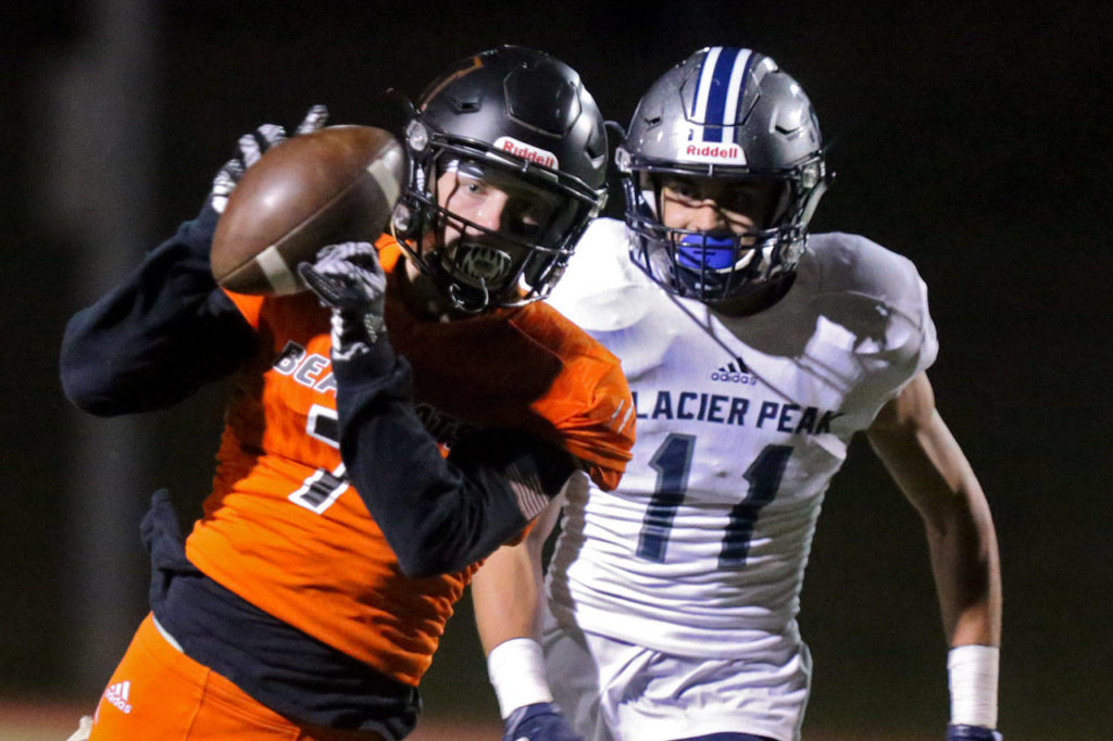 Monroe’s Efton Chism III hauls in a reception with Glacier’s Peak Dawson Crosby trailing Friday night at Monroe High on Sept. 29, 2017. (Kevin Clark / The Herald)
