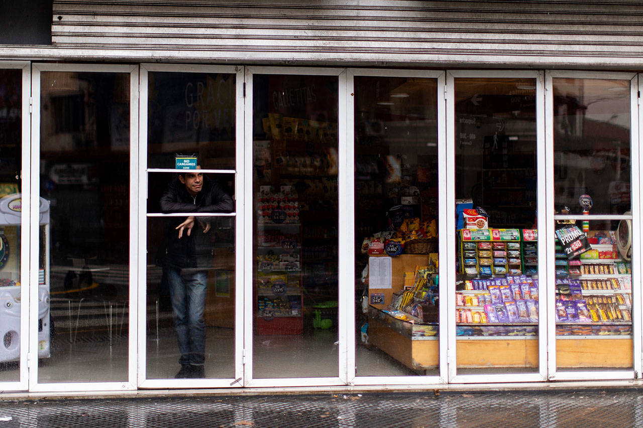 A man stands inside a store without power during a blackout, in Buenos Aires, Argentina, Sunday, June 16, 2019. Argentina and Uruguay were working frantically to return power Sunday, after a massive power failure left large swaths of the South American countries in the dark. (AP Photo/Tomas F. Cuesta)