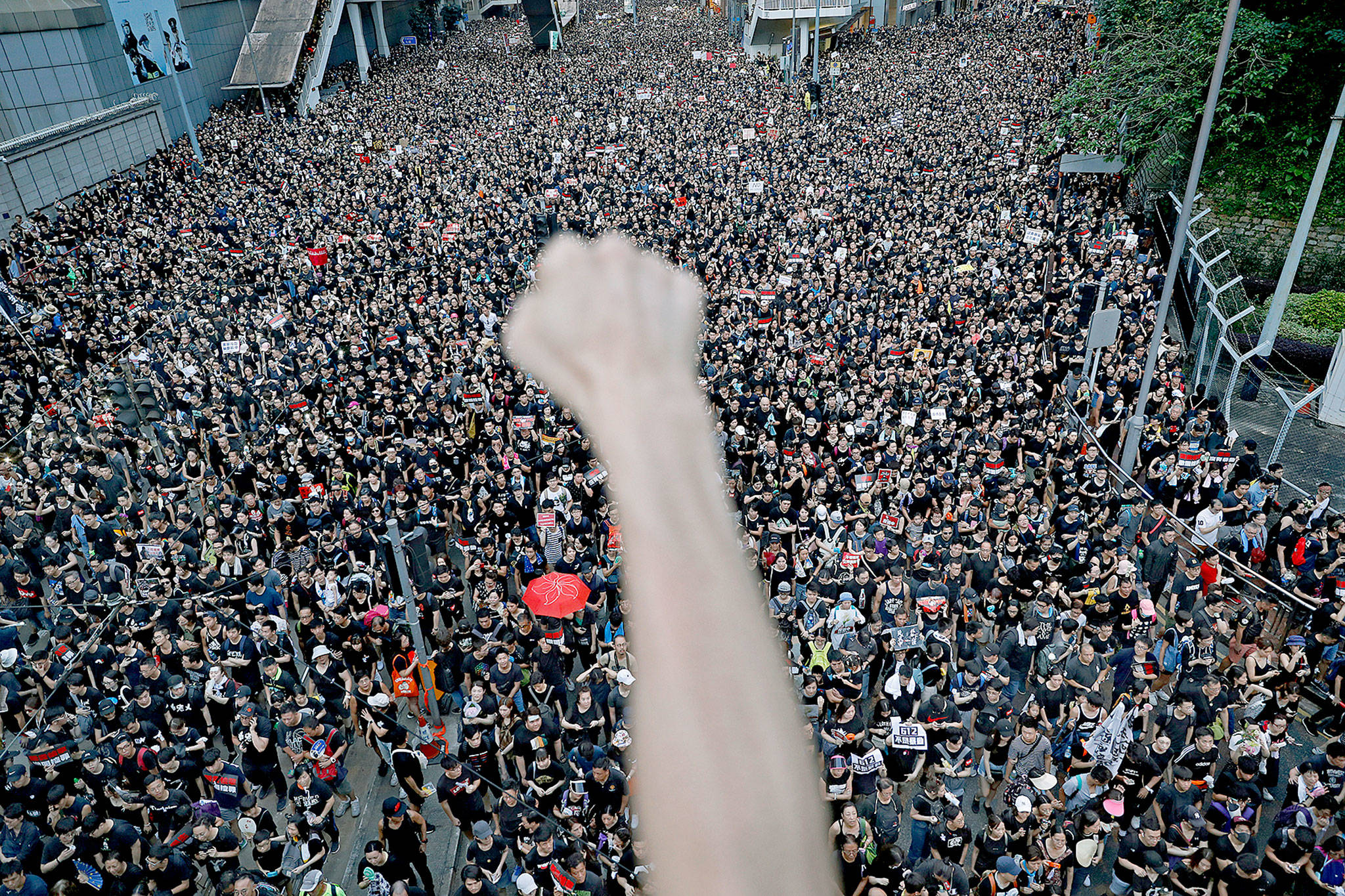 A protester clenches his fist as tens of thousands march in the streets of Hong Kong on Sunday. (AP Photo/Vincent Yu)