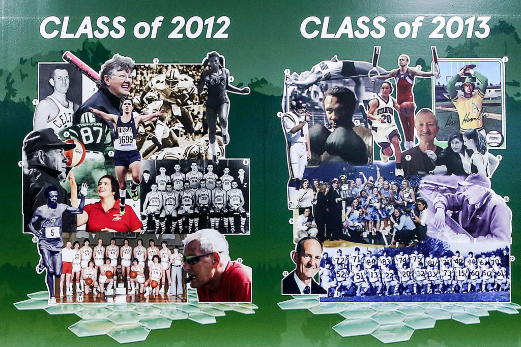 The Snohomish County Sports Hall of Fame’s induction classes of 2012 and 2013 are displayed as part of a new mural at Everett’s Angel of the Winds Arena. (Kevin Clark / The Herald)

