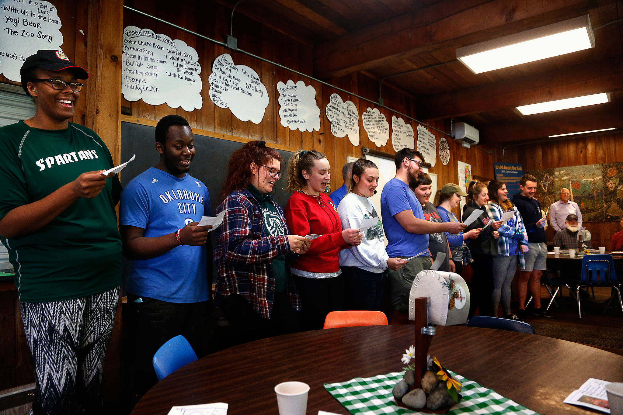 Staff who’ll be overseeing kids at Camp Killoqua this summer sing a song Thursday thanking donors to a capital campaign that raised almost $2.2 million for local Camp Fire programs. (Dan Bates / The Herald)