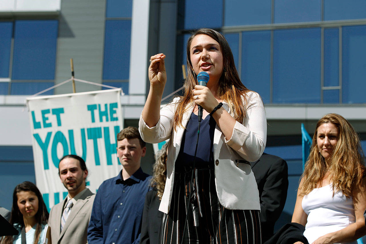 Kelsey Rose Juliana, of Eugene, Oregon, speaks at a June 4 rally in Portland for a group of young people who filed an environmental lawsuit against the U.S. government. Oregon is on the precipice of becoming the second state after California to adopt a cap-and-trade program, a market-based approach to lowering the greenhouse gas emissions behind global warming. (AP Photo/Steve Dipaola, File)