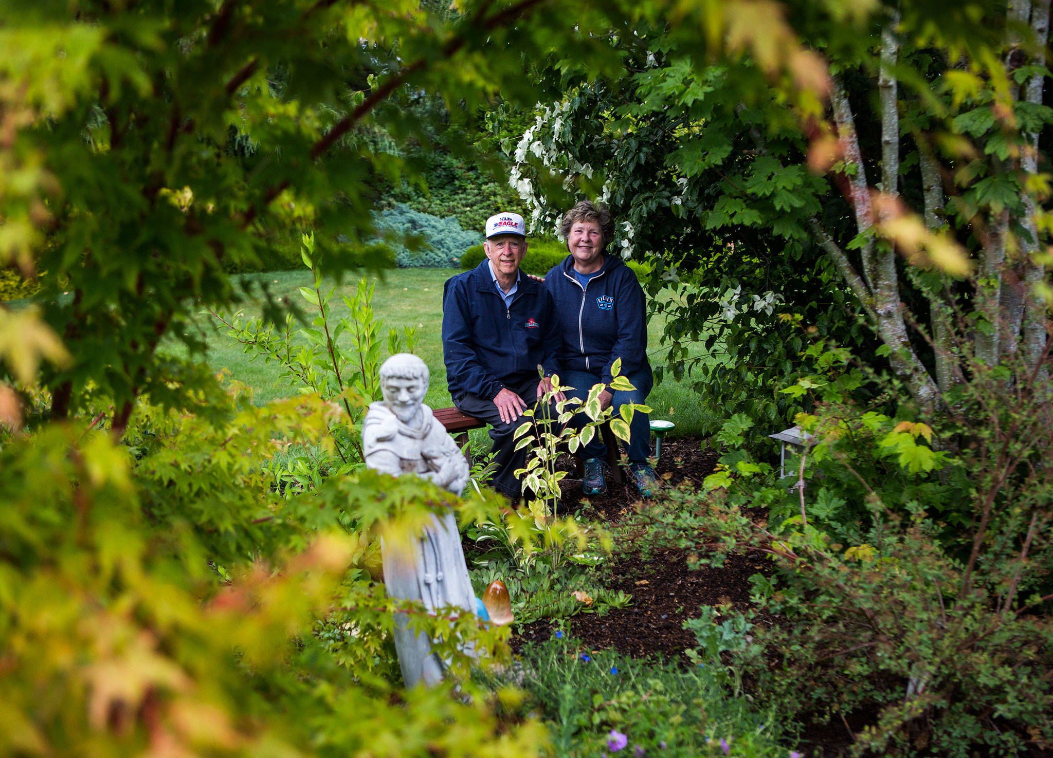 Kathy and Dave Hope in their Snohomish yard. Their garden, informally known as “The Park,” will be one of six featured on the Snohomish Garden Tour on June 30. (Olivia Vanni / The Herald)