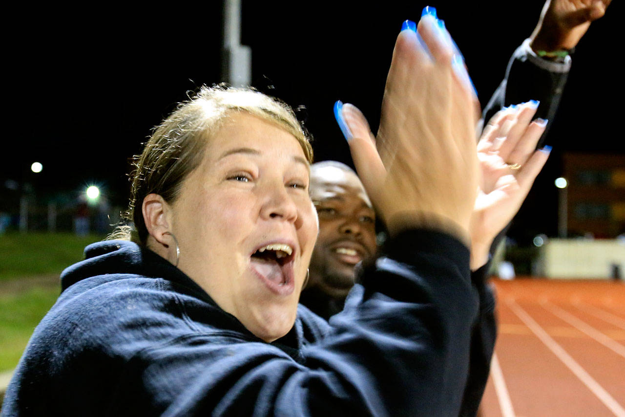 Sabrie and Steve Taylor cheer on their daughters during a 2016 soccer game at Marysville Getchell High School. The parents are starting a drop-in center for young people who have no where to go at night. (Kevin Clark /The Herald)