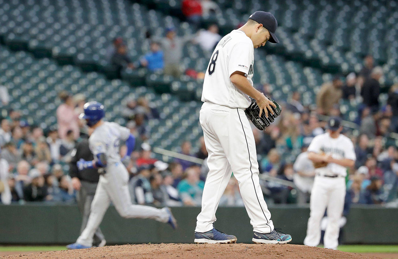 Seattle’s Yusei Kikuchi (right) looks down as Kansas City’s Whit Merrifield rounds the bases on the first of his two home runs in the Royals’ x-x win over the Mariners on Tuesday in Seattle. (AP Photo/Elaine Thompson)