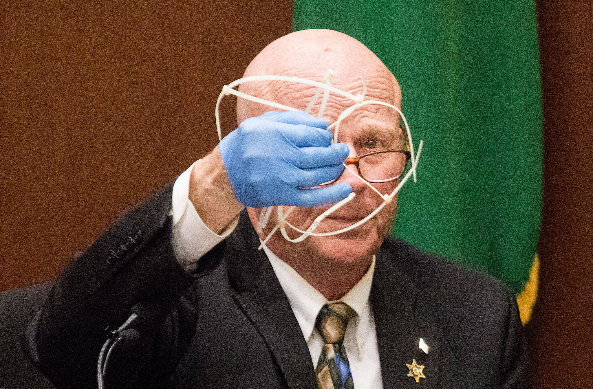 Retired Snohomish County detective and sheriff Rick Bart displays a group of zip ties, found near the body of Jay Cook, during his testimony at the trial for William Talbott II on Wednesday at the Snohomish County Courthouse in Everett. Talbott is on trial for the double-murder of Tanya Van Cuylenborg and Jay Cook. (Andy Bronson / The Herald/POOL)