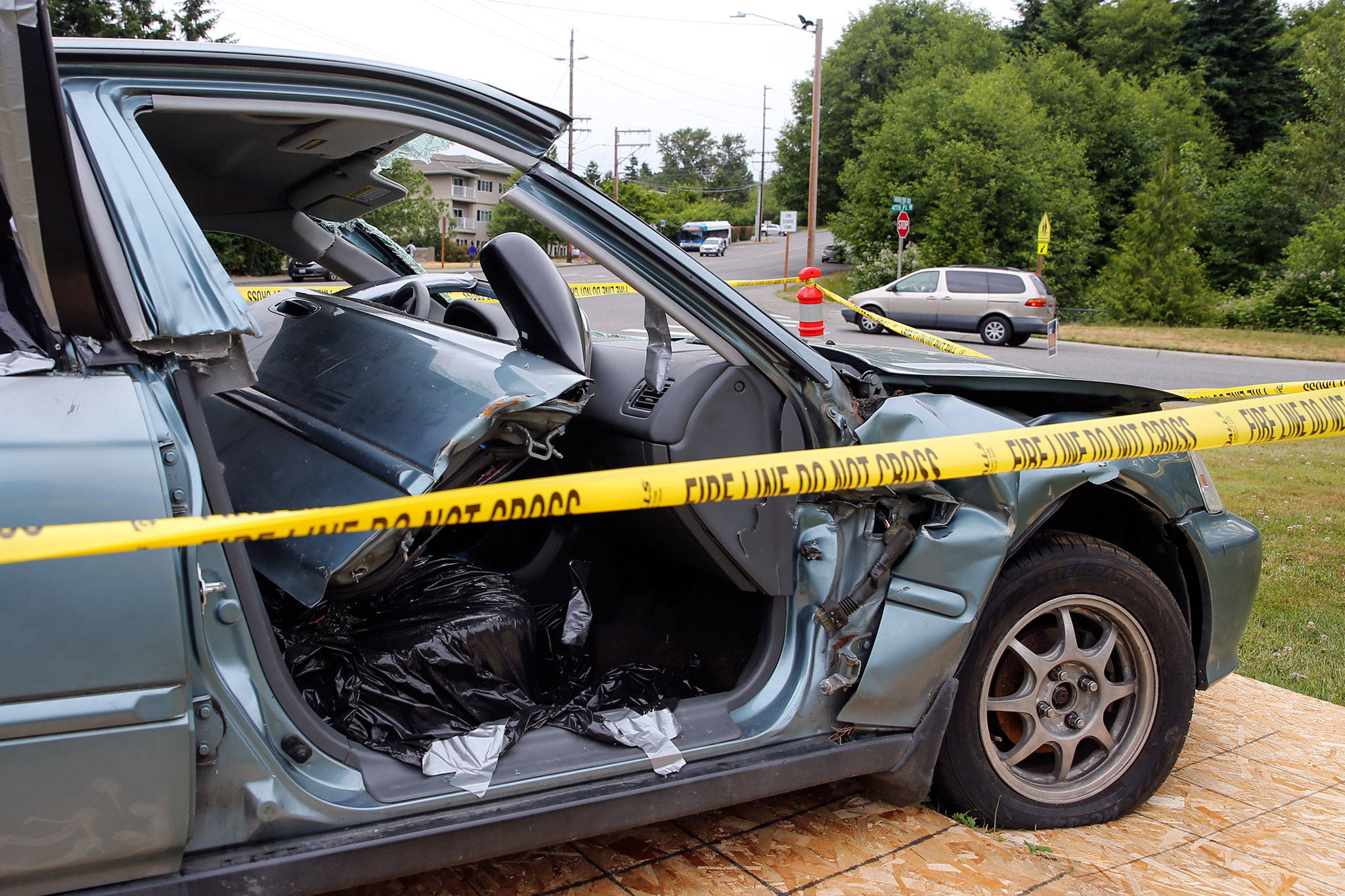A wrecked car on display at the Mukilteo Fire Department is a warning message about the dangers of texting and driving. (Kevin Clark / The Herald)