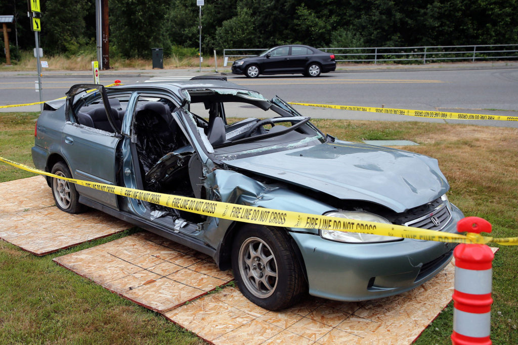 The totaled car was used in a recent mock crash event at Kamiak High School to warn students about the dangers of distracted driving. (Kevin Clark / The Herald)
