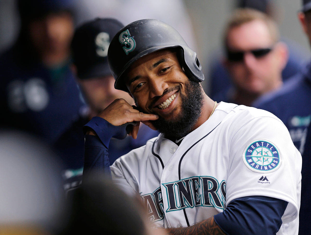 The Mariners’ Domingo Santana celebrates in the dugout after hitting a solo home run during the seventh inning of a game against the Royals on June 19, 2019, in Seattle. (AP Photo/John Froschauer)