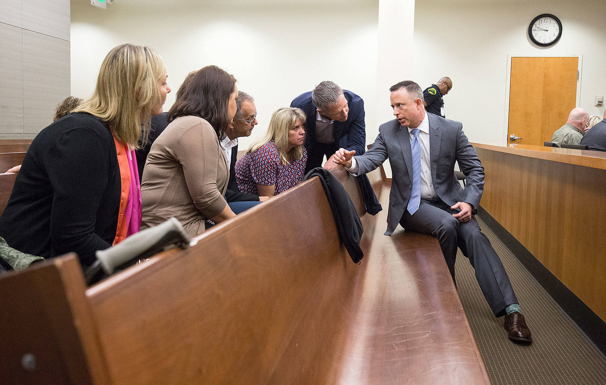 Deputy prosecutor Matthew Baldock (right) talks to victim family members and friends at the trial of William Talbott II at the Snohomish County Courthouse on Friday in Everett. Talbott is on trial for the 1987 murders of Tanya Van Cuylenborg and Jay Cook. (Andy Bronson / The Herald/POOL)