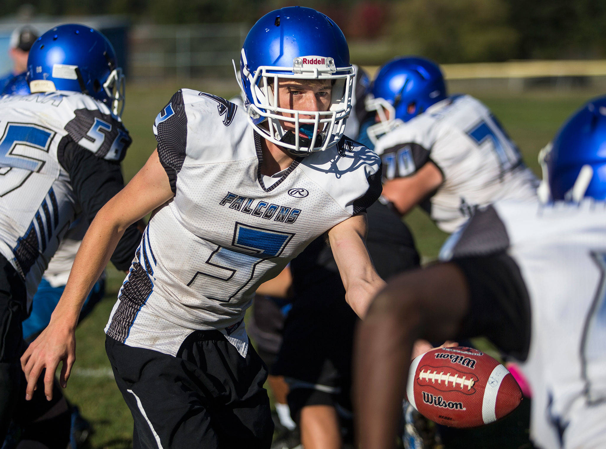 Quarterback Kody Newman hands the ball off during football practice at South Whidbey High School on Oct. 16, 2018 in Langley. (Olivia Vanni / The Herald)