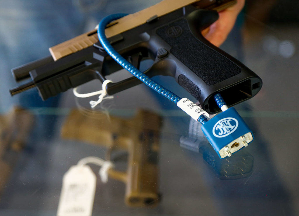 A semiautomatic handgun with a safety cable lock that prevents loading ammunition. (Dan Bates / The Herald)
