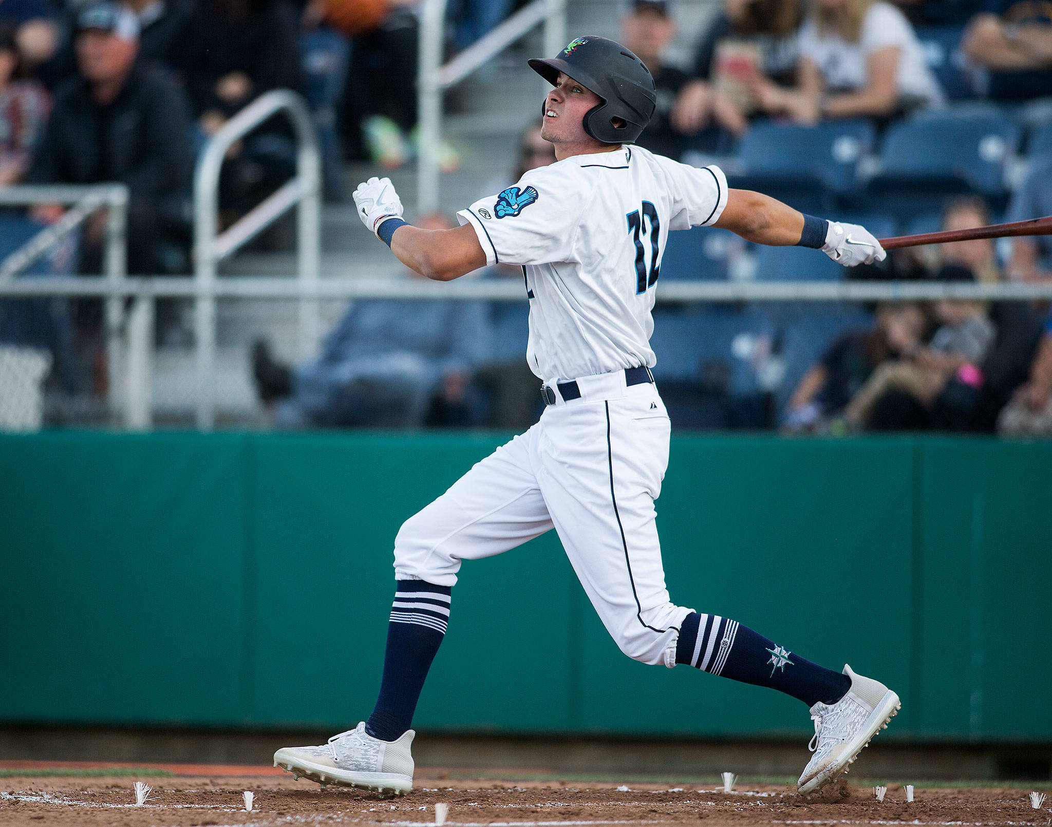The AquaSox’s Cash Gladfelter watches as his ball sails over the wall for a three-run homer during Everett’s home opener against the Volcanoes on June 21, 2019, at Funko Field at Everett Memorial Stadium. (Andy Bronson / The Herald)